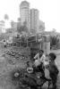 Mother Cooking Food, boy, son, Shanty Homes, Shack, apartment buildings, slum, Mumbai, India