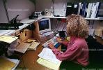 Woman, desk, paperwork, paper stacks, pile, cubicle, 1990's