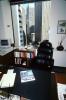 Desk, Chair, phone, glass pyramid, books, book shelf, table