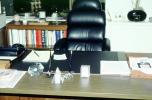 Desk, Chair, phone, glass pyramid, books, book shelf, table