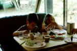 Brother and Sister eating lunch in an Recreation Vehicle, RVCV02P11_01