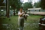 Lady with her fish catch, campsite, 1960s