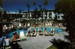 Poolside, Men, sun tanning, lounge chairs, Hotel, 1980s