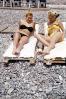Pebbles, rocks, Sand, women, lounging, Women Sunning, Beach, bikini, sun worshiper, 1970s, RVLV07P02_06