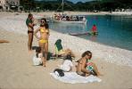 Beach, sand, woman, bikini, boat, lake, water, towels, Corfu Island, Greece, 1960s