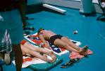 Woman tanning, confederate battle flag towel, bikini, 1965, 1960s, RVLV07P07_16