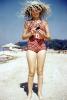 Girl on a beach, Suntan, sunburn, sun exposure, summer, hot, heat, summery, sunny, hat, 1950s, RVLV08P09_17