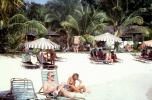 Beach, lounge chairs, umbrellas, sand, palm trees, 1960s, RVLV09P06_10