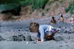 Boy making a sand castle, beach, toddler