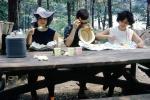 Women, hats, picnic table, 1960s