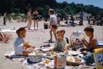 Girl and Boys on a Crowded Beach, food, towels