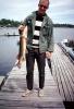 fishermen, man, fish, dock, pike, fish catch, Hudson Bay, Canada, 1969, 1960s, SFIV02P08_10