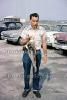 Fish Catch, Man, jeans, shirt, cars, Provincetown, Massachusetts, 1965, 1960s, SFIV02P14_17