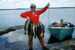Happy Camper, fish, fisherman, power boat, lake, water, fish catch, man, male, Manitoba, Canada, 1970, 1970s, SFIV03P01_01