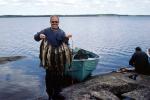 Happy Camper, fish, fisherman, power boat, lake, water, fish catch, man, male, Manitoba, Canada, 1970, 1970s, SFIV03P01_02