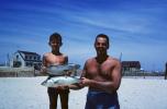 Boy and Father showing off fish catch, Cape Cod, 1950s, SFIV03P04_18