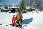 Father and Daughter Sitting in the Snow, 1950s, SKFV01P05_13