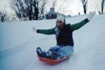 Girl Sliding down a hill in the Snow, smiles, mittens, SKFV01P06_18