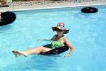 Woman Floating, Inner-tube, legs, hat, sunglasses, Swimming Pool, SWFV01P11_12