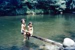 Two Girls sitting over a gentle River, 1940s, SWFV02P12_14
