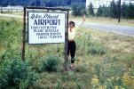 Lake Placid Airport Sign, Happy Woman Greeting, 1960s