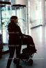 Woman Pushing Baggage Cart at SFO, TAAV09P04_14