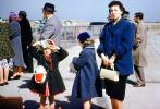 Waiting for Airplane, Woman, purse, formal, coat, caps, daughters, 1950s, TAAV15P05_06