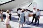 Passengers getting ready to board, men, women, hats, dresses, wind, windy, 1950s, TAFV44P03_11
