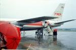 N759TW, Boeing 707-131B, JT3D, passengers boardking, rain, umbrellas, 1960s