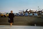 Woman Standing at the Airport, cars, N6227C, L-1049, EAL, 1955, 1950s, TAFV46P02_03