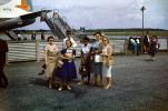 N476A, Martin 404, Mother, Daughter, smiles, Passengers waiting to board flight, 1950s, TAFV46P11_10