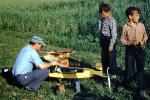 Boys watching father prepare airplane for flight, Man, guy, June 1959, 1950s