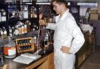 Man at a Chemistry Lab, coat, nots, test tubes, 1950s, TCLV02P11_19