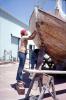 Woman Scrapes the Hull of a Boat, TSDV02P03_06