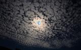 Moon with alto cumulus clouds