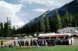 Passengers, Band Boarding Bus, Trailways Bus, cars, automobiles, vehicles, Banff, Alberta, Canada, 1962, 1960s, VBSV04P07_01