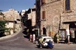Street scene, buildings, car, Assisi Italy, Fiat minicar, mini-car, AGIP Gas Station, October 1969, 1960s, VCOV01P01_18