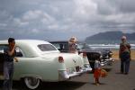 Cadillac, beach, Girl selling hats, cars, Kahana Bay, June 1956, 1950s, VCRV21P13_17