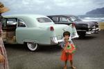 Cadillac, beach, Girl selling hats, cars, Kahana Bay, June 1956, 1950s