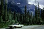 1958 Plymouth Fury, fins, four-door sedan, dirt highway, trees, forest, August 1962, 1960s