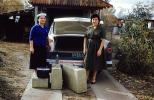 Women Packing Suitcases, luggage, Ford Customline, 1950s