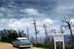 Oldsmobile, clouds, trees, MacKenze Mountain, 1954, 1950s, VCRV23P02_01