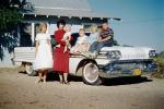 Family Sits on an Oldsmobile car, 1950s, VCRV24P01_04