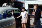 Woman Enters her Ford Customline Car, 1950s, VCRV24P11_09