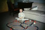 Boy and his toy railroad set, tracks, Pajamas, sofa, 1960s, VRMV01P04_01