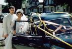 Wedding Couple enters Car, Suburbia,  1950s, WEDV01P05_07B