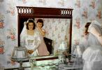 Woman prepares for her wedding, mirror, satin dress, 1940s